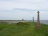 The war memorial with the castle and harbour in the background