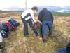 Venetia and Andy help Graham under the deer fence!