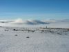 A lone walker looks out over the cloud